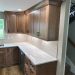 Kitchen remodel by DreamMaker in Central Texas featuring white marble countertops and sleek wooden cabinetry.