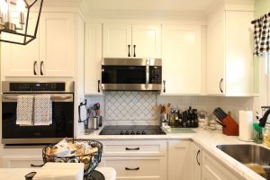 Bright white cabinets with complimentary black and stainless steel appliances