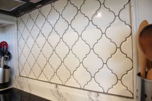 Patterned tile backsplash ties the room together
