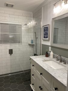Farmhouse bathroom vanity with wood paneling wall