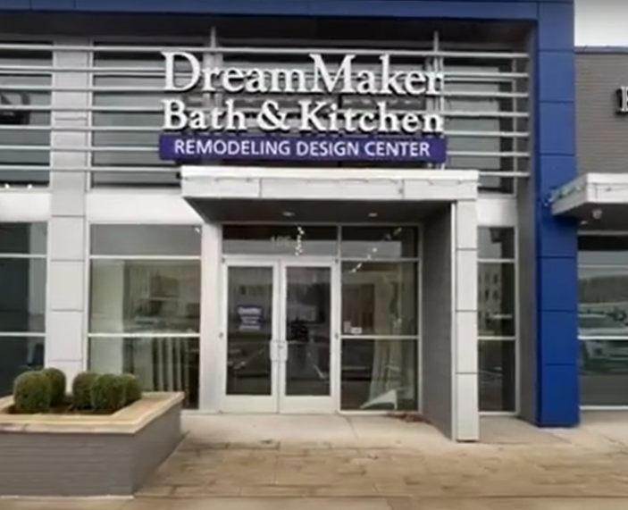 DreamMaker Bath & Kitchen Design Center exterior entrance with glass doors and branded sign