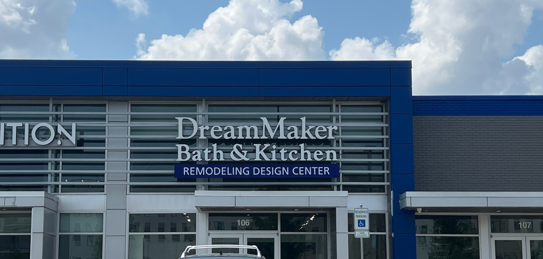 DreamMaker Bath & Kitchen Design Center exterior entrance with glass doors and branded sign